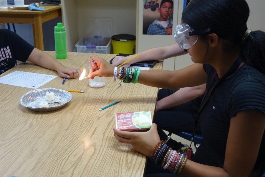 Janelle Creager lights a match in Mr. Buches 7th hour science class as part of an experiment.