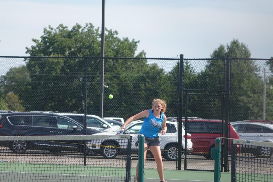Kailyn Petersen returns the ball to the opponent at a Singles match on the WRHS tennis courts. Petersen uses the brand ‘Head’ for her racket and bag and says “I am excited to play doubles.”