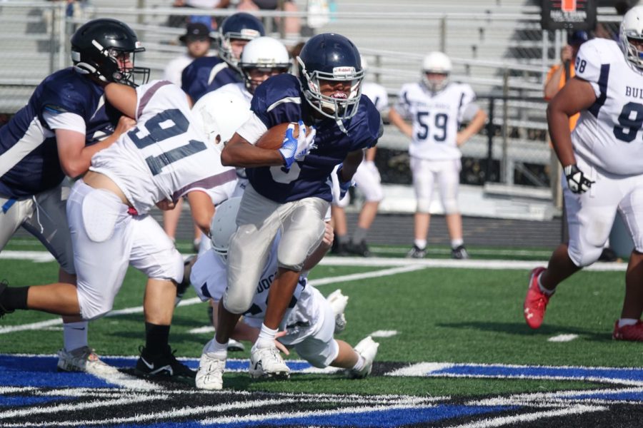 7th grade running back Myles Bradley runs the ball towards the end zone, Bradley said he is looking forward to scoring touchdowns. He also says “I have scored 1 touchdown, 300 rushing yards, and more to come.”