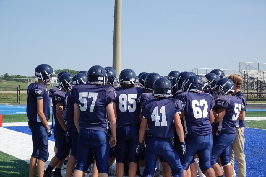 The 8th Grade football team huddles at the game September 8th against Junction City. The Falcons defeated Junction City 51-0. Kicker Ryan Austin said before the game, “I’m looking forward to kicking.”
