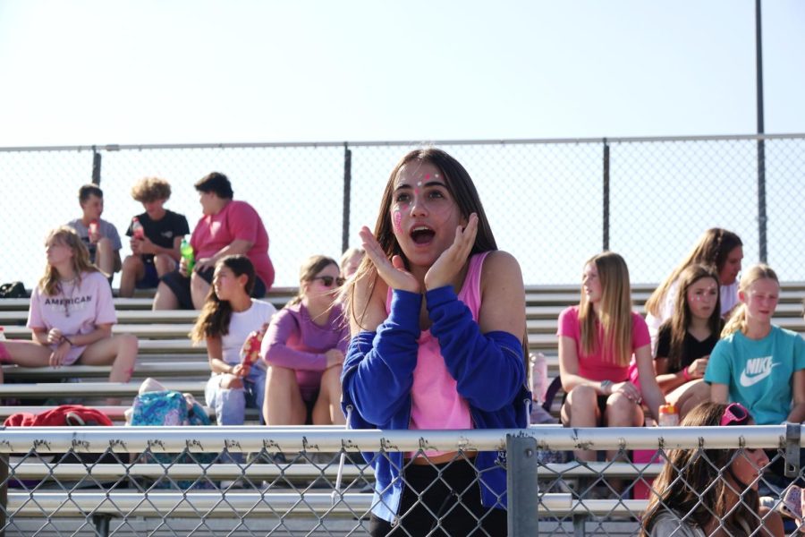 8th grader Alayna Starkebaum shows emotion at the football game on October 6th against Manhattan Eisenhower. “I love watching the football games, theres always so much energy and action. Its always fun,” Starkebaum said.