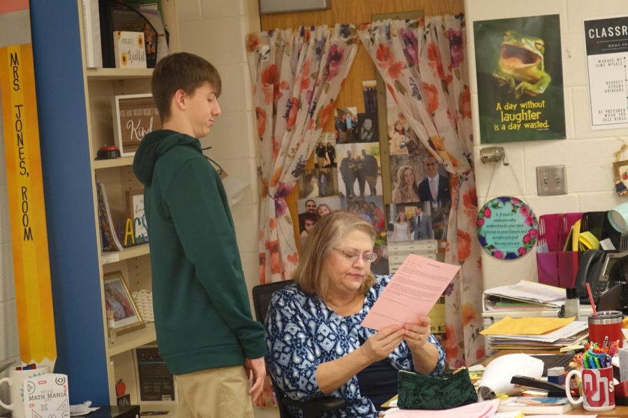 On January 26th in classroom B8, Mrs. Jones explains the cookie sale-supply and demand worksheet to 8th grader Preston Bahr to help him understand while working with his partner.  Story by Kadee St.Cyr.  