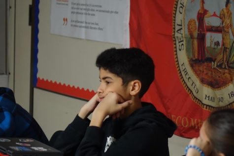 On January 25th, in Mr. Mills social studies classroom, 7th grade student Dominic Vargas watches an educational video on Mr. Mills’s smartboard to learn more about John Brown and his background. Story by Max Bervert.
