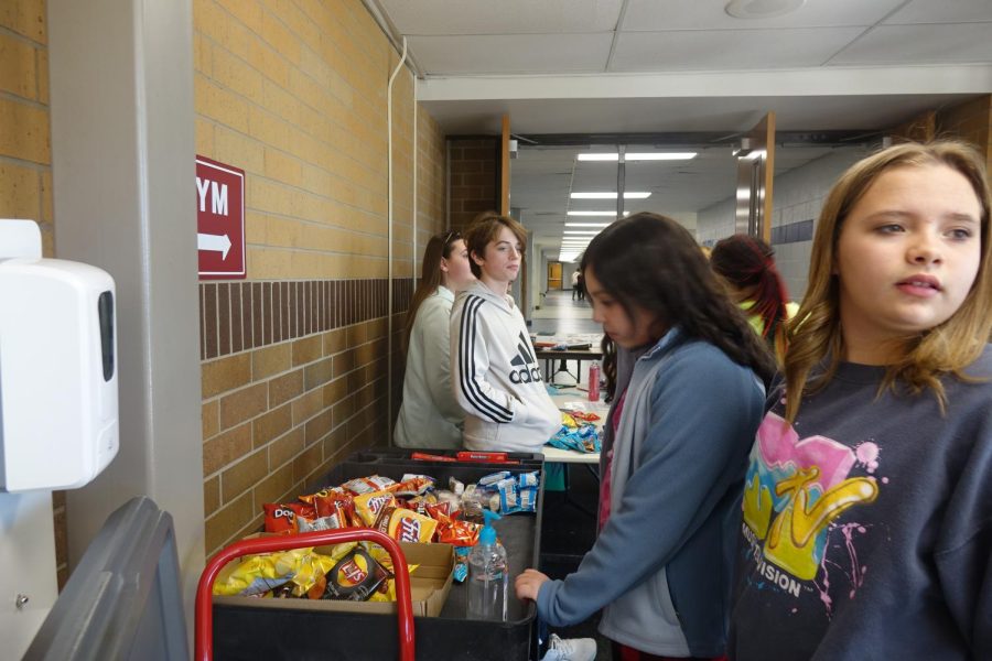 Addy Sanchez looks at 
the snack options at the snack sale during lunch.