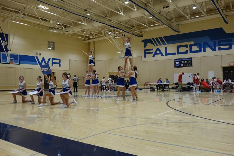 The seventh grade cheer squad performs their quarter cheer, “Go Fight Win” during the 7th grade boys basketball game on January 10th in the WRMS A Gym.