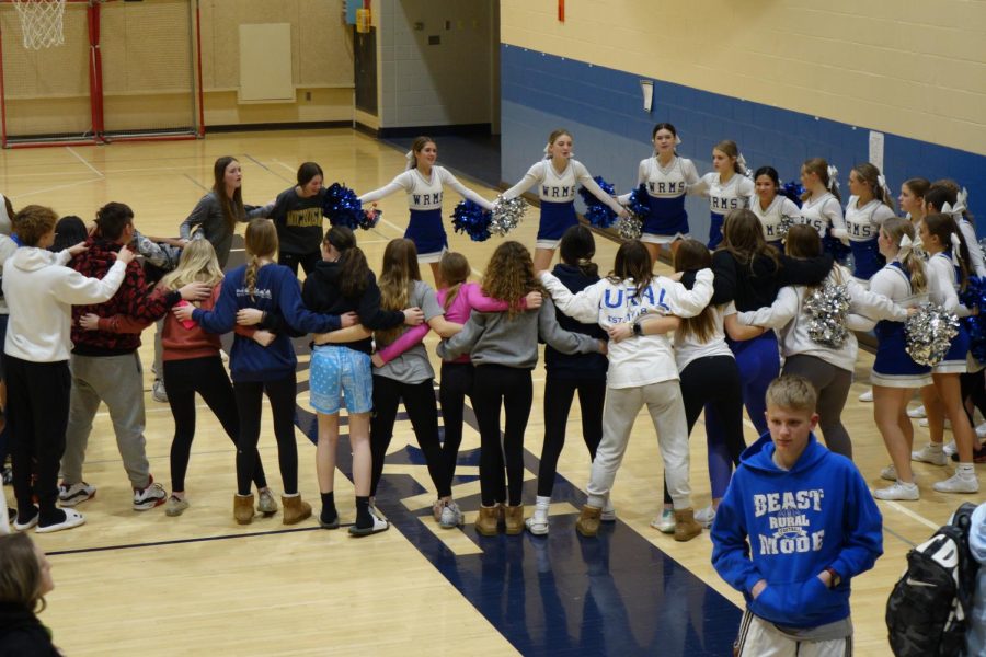 The student section joins the 8th grade cheer team during their end of the game “Color Shout” on January 19th in WRMS A Gym.