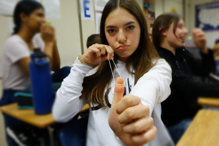  On Thursday March 9th, 8th grader, Julia Katzer shoots a rubber band at the camera as Mr. Johnstons class cleans out their binders, lockers, and folders for the end of the quarter.
Caption by Janna Marquis.