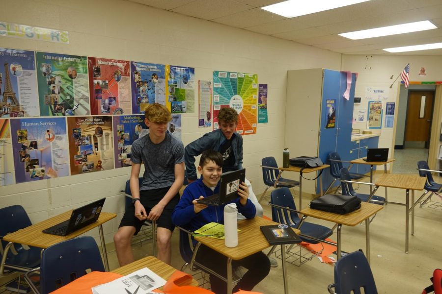 8th graders Rex McIlvain, Nills Martinson, and Austin Smith finish research for their target market activity in business FACS on Thursday, March 30th, during 3rd hour. Caption by Jordynn Hill