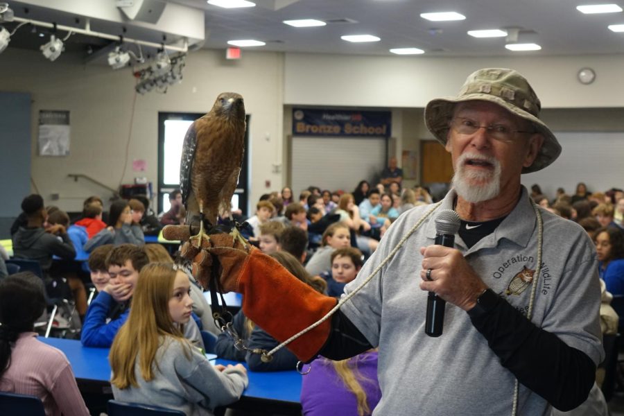 Mr. Tubbs poses for a picture during the presentation about their rescued birds to 7th graders. 