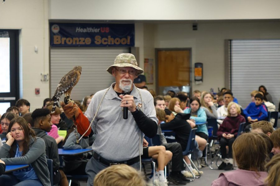 Mr. Tubbs shows the students a red shouldered hawk named Blaze, rescued by the Operation Wildlife by having it stay on his arm with a special glove on March 29th.
