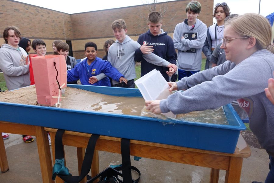 On April 3rd, Mrs. Casey aggressively pushes the water to make a wave to knock over the structures.




