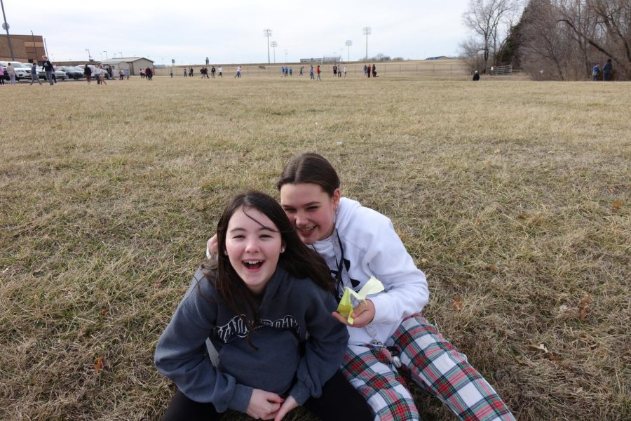 On January 1st 8th graders Karessa Shook and Rylie Wessel Sit outside Laughing in the grass during tidal wave tuesday.  