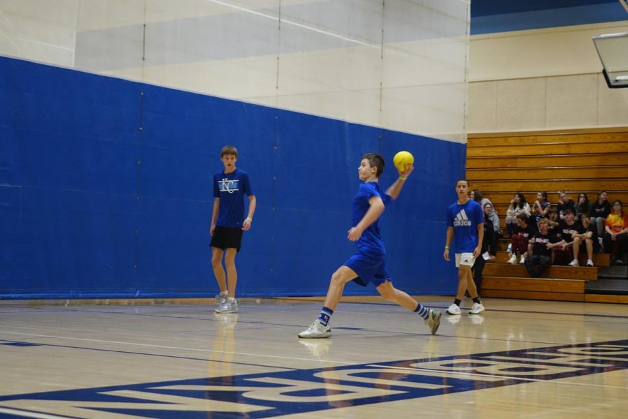 On January 27th, Caleb Menke (8) throws a dodgeball to the opposing team while the other teams watch, for the dodgeball tournament made possible by WRMS with Mrs. Dowell in charge.