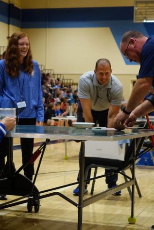 Voyager Math teacher, Miss Henley, and 8th grade principal, Mr. Dial, cheer on Voyager social studies, Mr. Mills as he competes in Minute to Win it Challenges.