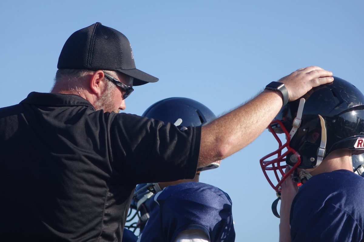 On August 31st at the WRHS football field, Coach Willis encourages one of his 7th grade B team football players on the sidelines at the Shawnee Heights game. Story by: Jonathan Remigio. 