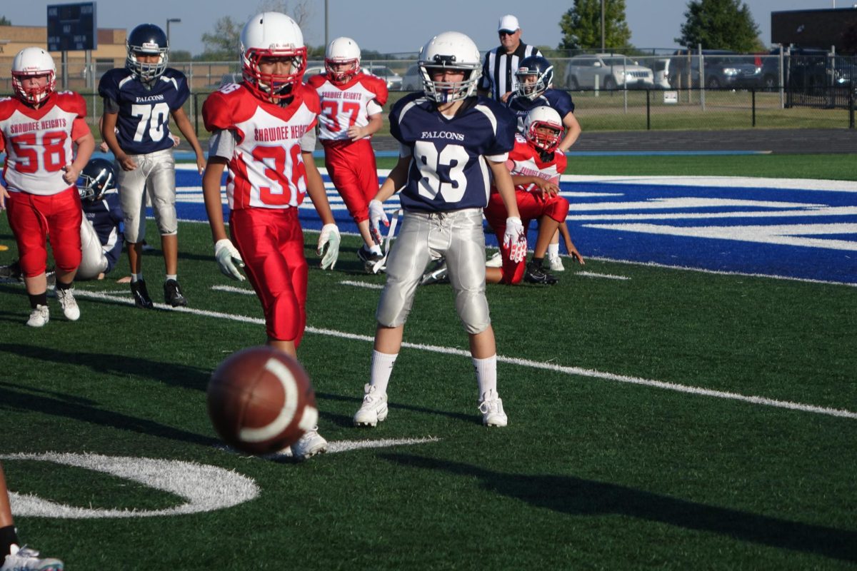 On August 31st, at the 7th grade home football game against Shawnee Heights, at WRMS, Victor Carter (70) and Jensen Lamb (83), look at a ball that has just been fumbled.


