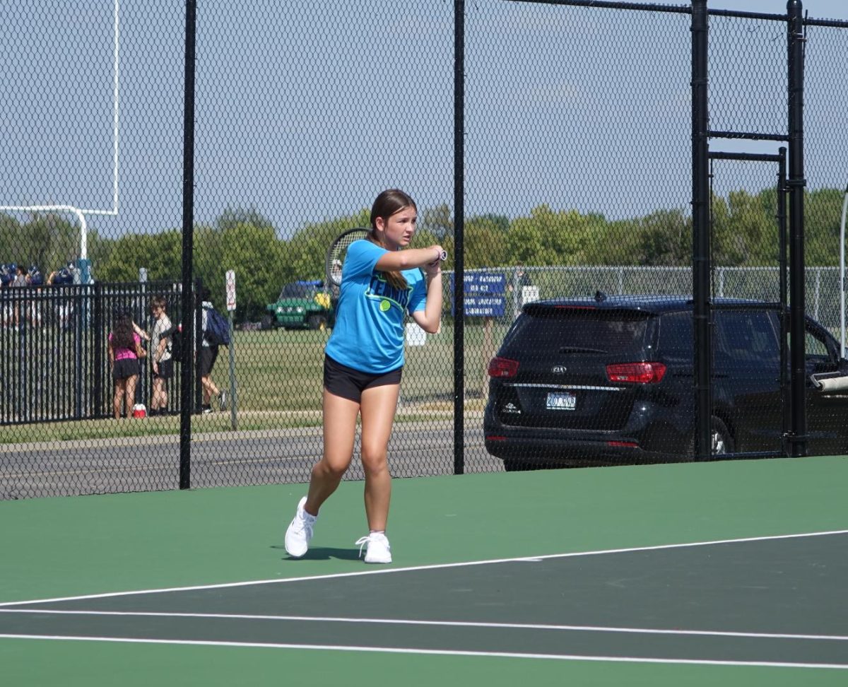 On Tuesday, September 12th at the WRHS tennis courts, 8th grader Liz Halstead hits the ball back to her opponent during the meet against Seaman. 