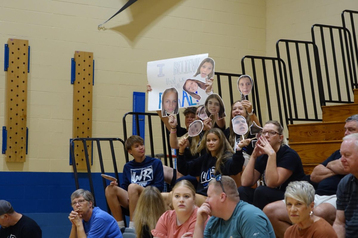 On Saturday, September 16th, at the volleyball tournament hosted by WRMS, fans celebrate a point scored by the 8th grade B team, using posters and cutouts of the players.