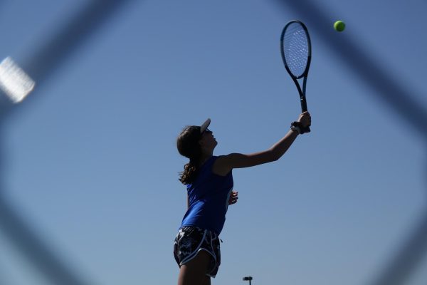 8th grader Isabella Vaidya serves the ball during a girls tennis match against Seaman on September 5th.
