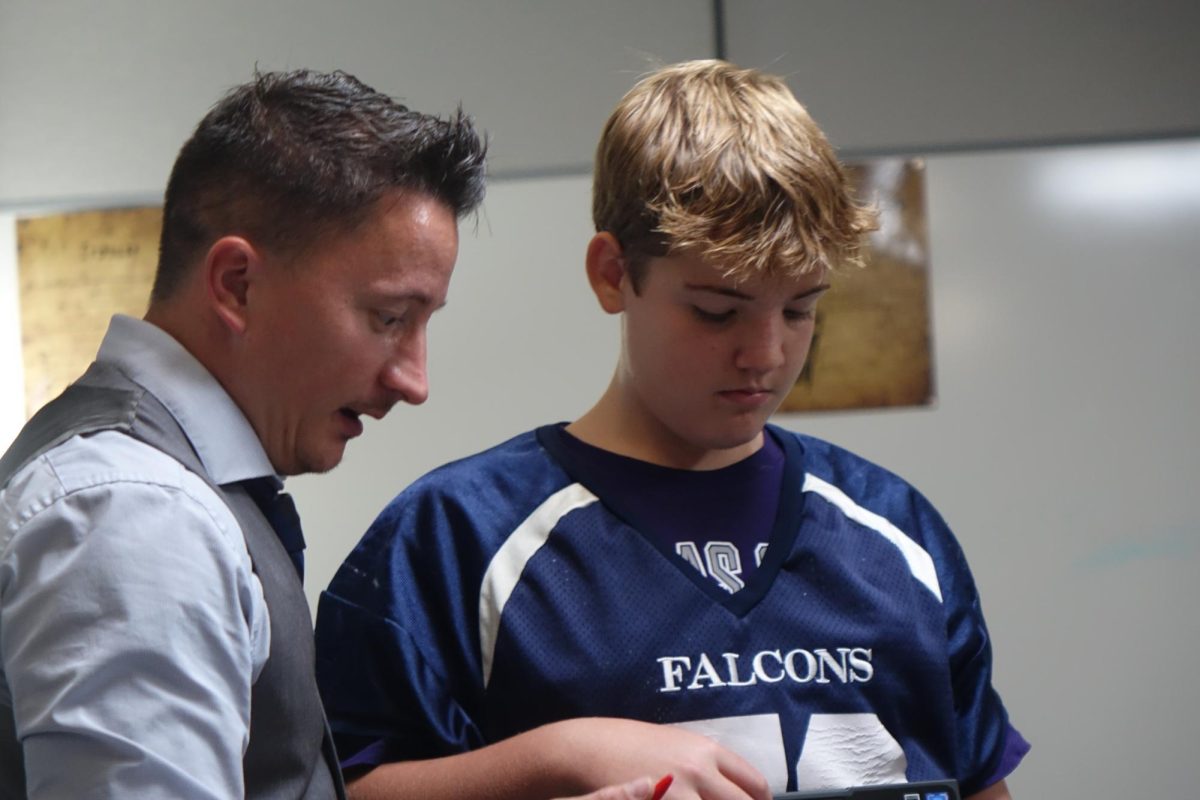 On September 21 7th grade Comets Language Arts teacher, Mr. Brown, assists one of his students.