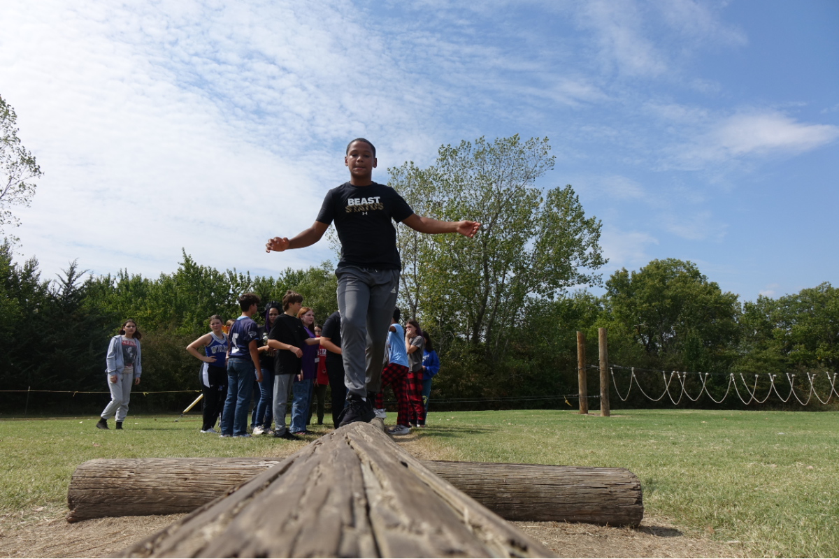 On September 21st, 8th Grader Paxton Poe walks across a log teeter totter at the middle school challenge course, while trying to balance his weight so he doesnt fall.
