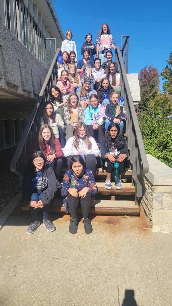 25 Washburn Rural 7th grade girls, sit on the stairs at Washburn University, while waiting to start Women In Science Day on October 16th.