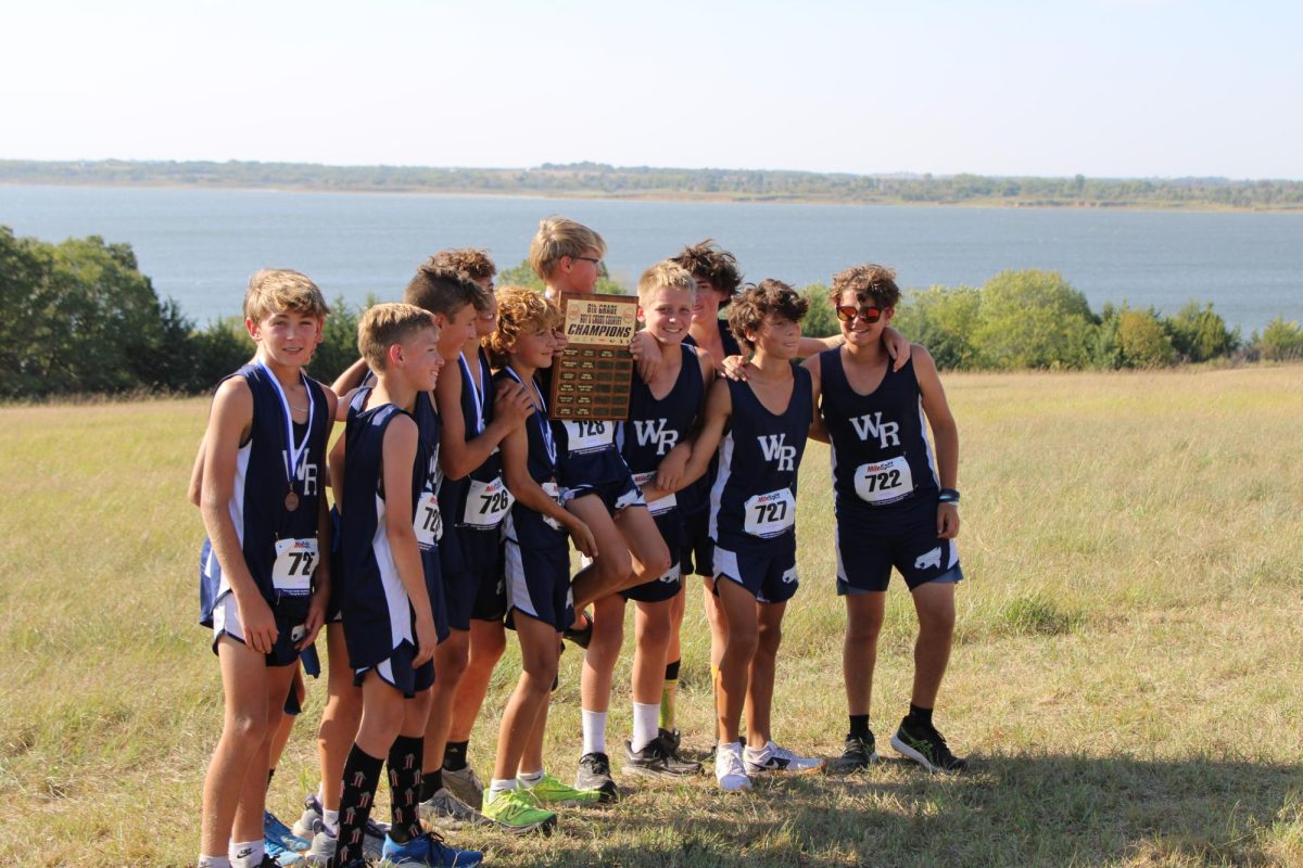    On September 29th, the 8th grade boys pose for a photo with the trophy they won for winning the race for CML, which is their last cross county meet for the season. 