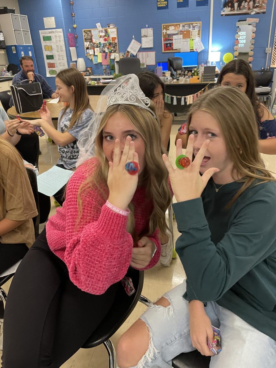Makenna Lee and Ellie Vogel pose with their Ring Pop rings, after showing their dedication to the book by sharing vows in the pressroom on October, 12th. 