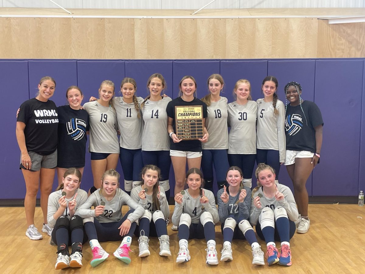 The 8th grade Washburn Rural volleyball team happily takes a picture, while posing with their medals and the CML plaque, after winning the championship match on September, 30th at Anthony Middle School. 