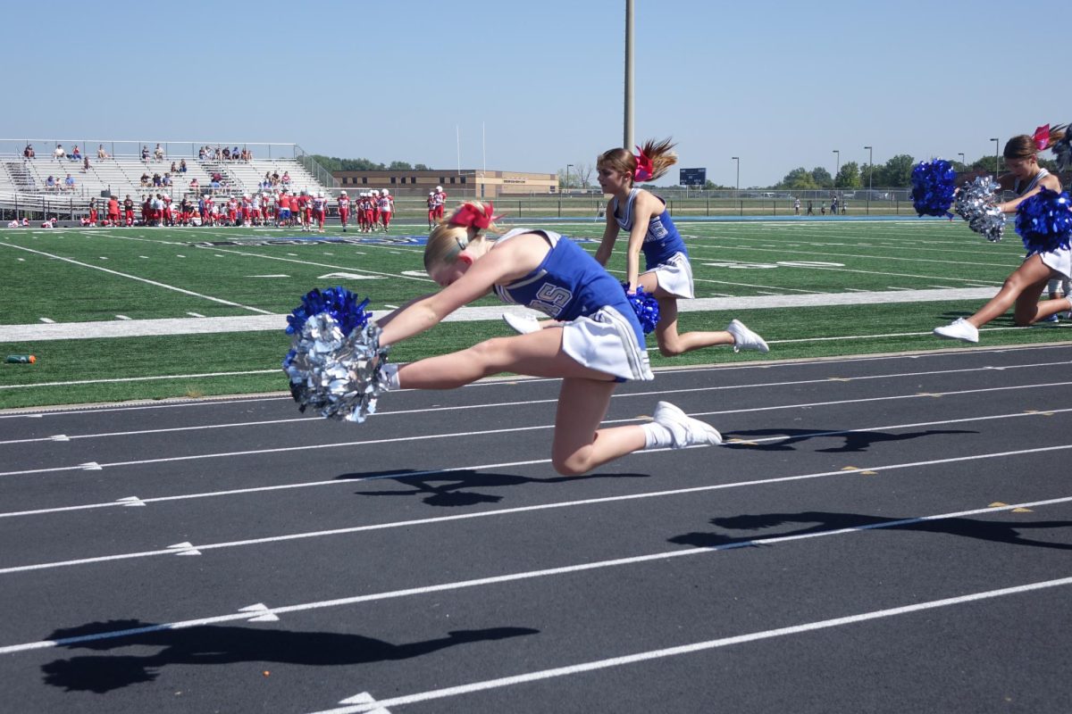 7th grade cheerleader, Kylin Buchman, does her right hurdler at the football game against Shawnee Heights on August 31st.