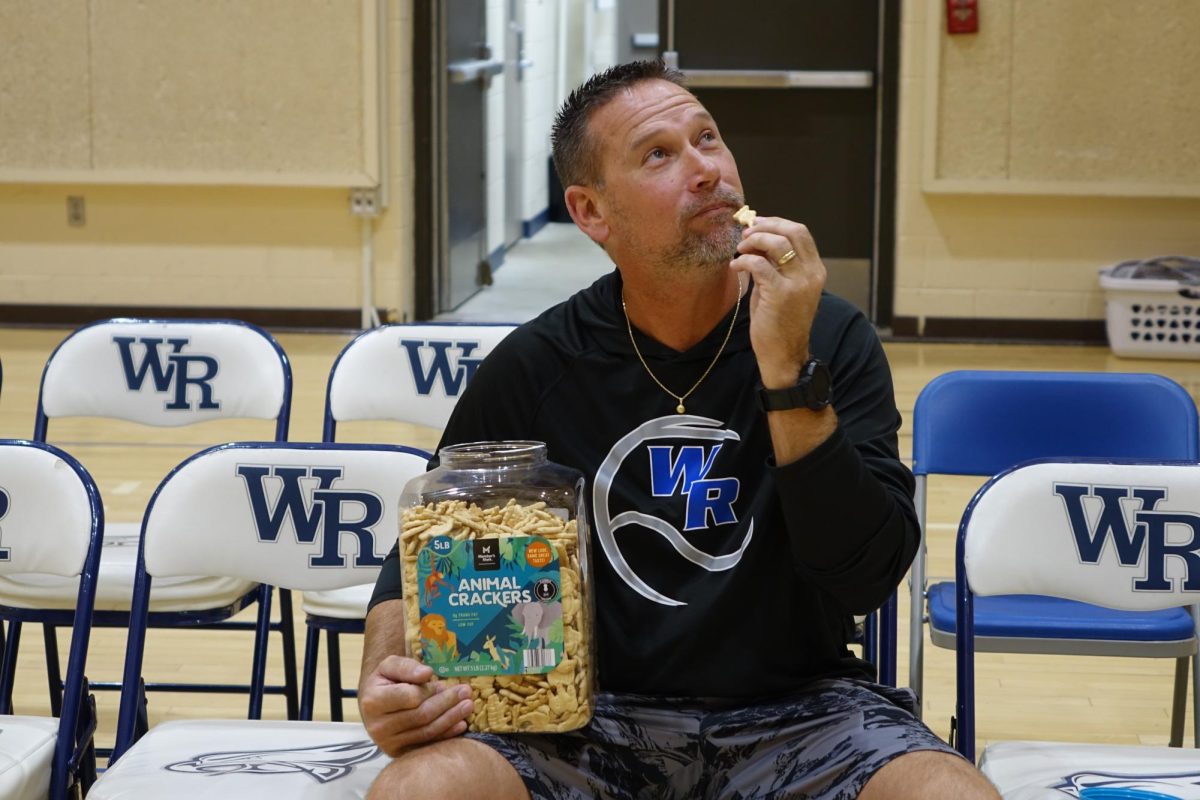 Coach Garland sits while he eats his beloved animal crackers.