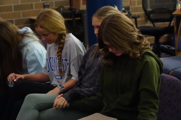 Ava Fritz, Anna Fowler, and Arianna Heble pray over the week on October 30th, after listening intently to the message. Fritz uses the lesson in her daily life, “I find the club helpful because it helps me stay centered and it helps me stay focused.”