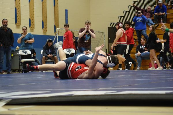 On November 29th, 8th grade boys wrestler Jax Johnson pins his opponent down and wins the match.
