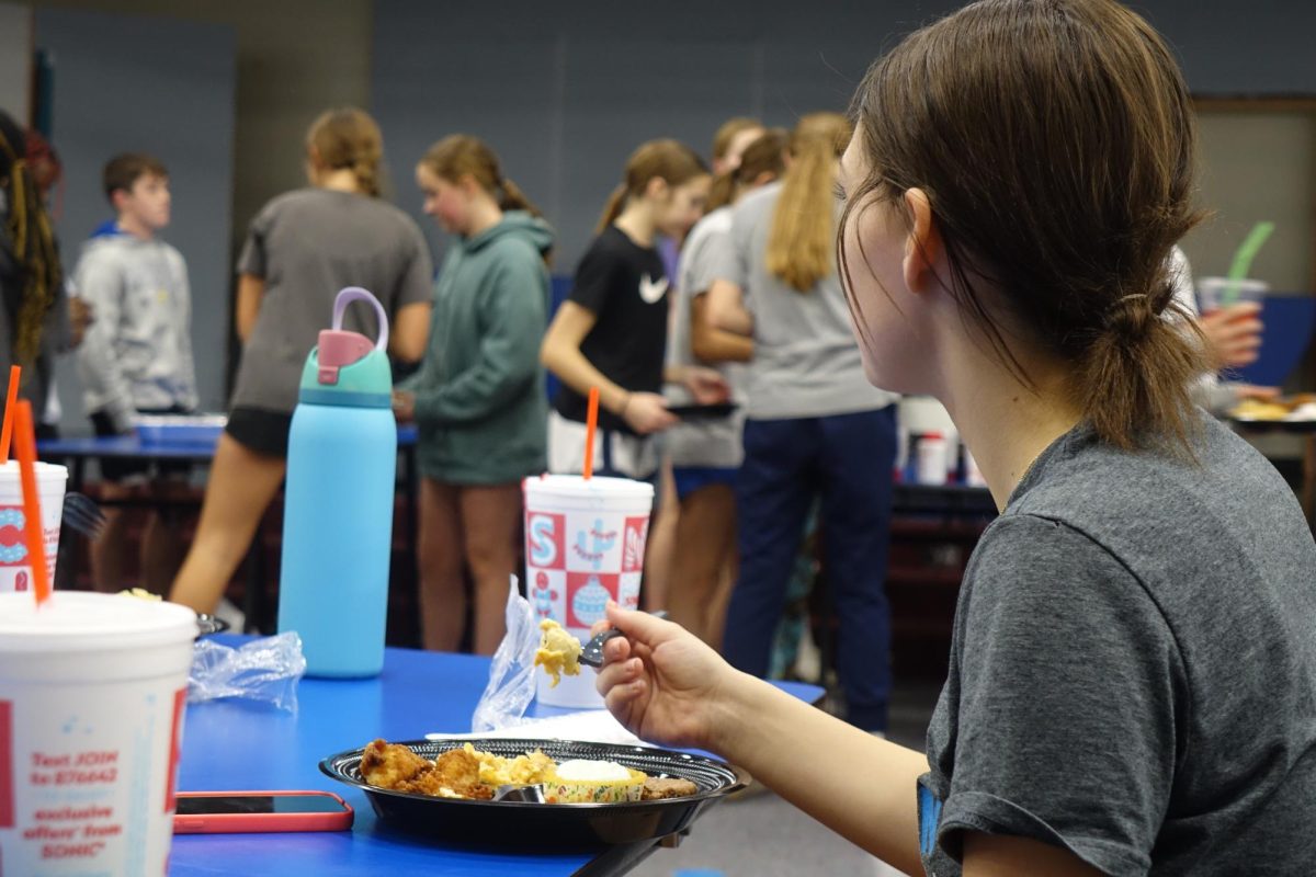 8th grade basketball player June Ennis enjoys her Chick-fil-a, after learning more about FCA at the girls basketball event on December 6th. 