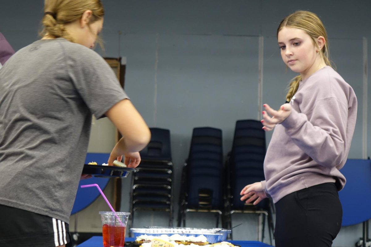 Makenna Lee directs the dessert table at the FCA girls basketball event on December 6th. Lee says that you have support when you are in the club, “I like that I am able to spread the word of God with my peers and to know that I am not alone in my walk with God.”