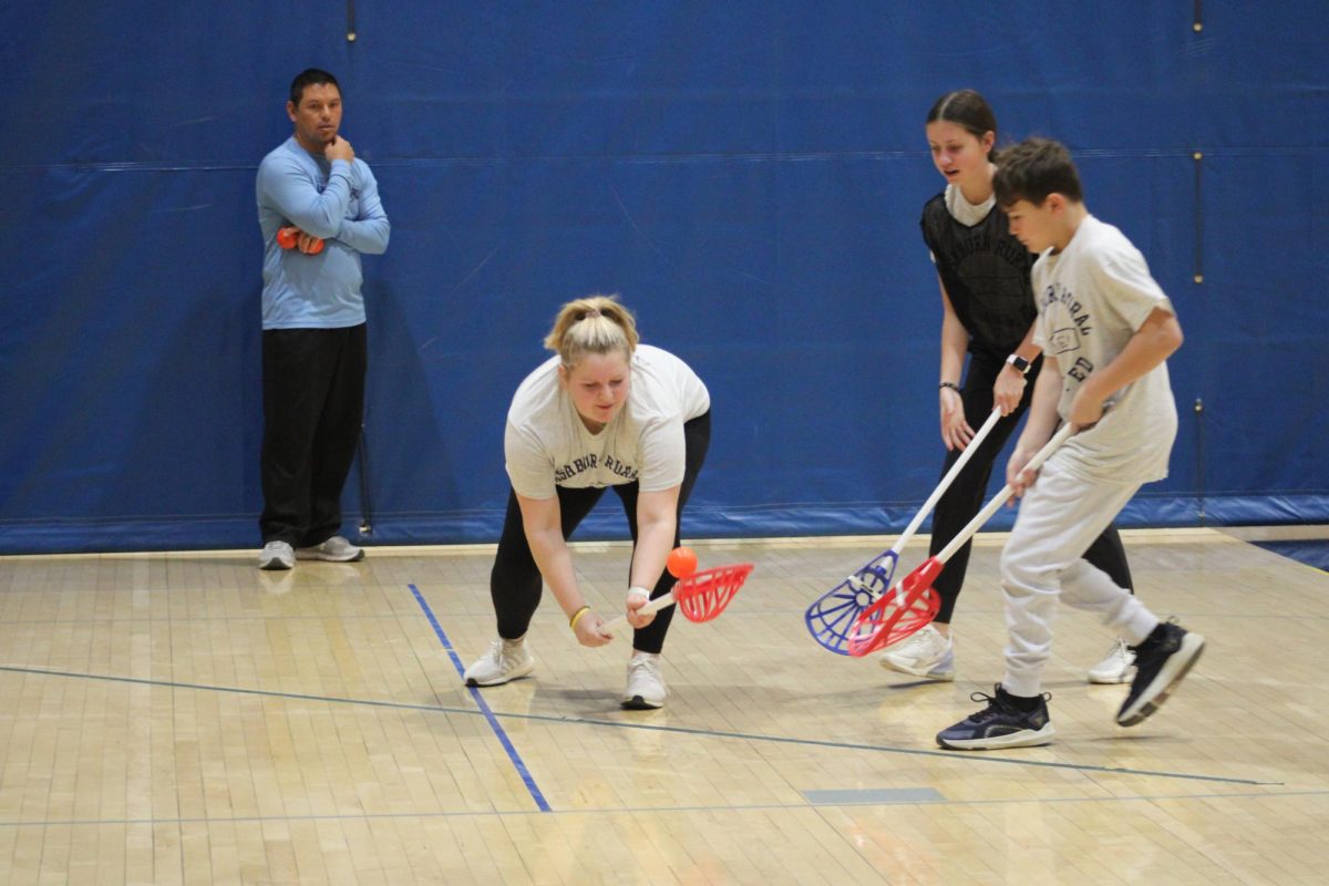 On January 25th, Macy Ahrens scoops up the ball, while her opponent Rylee Bauer tries to take it away in 3rd hour PE during their lacrosse unit. 