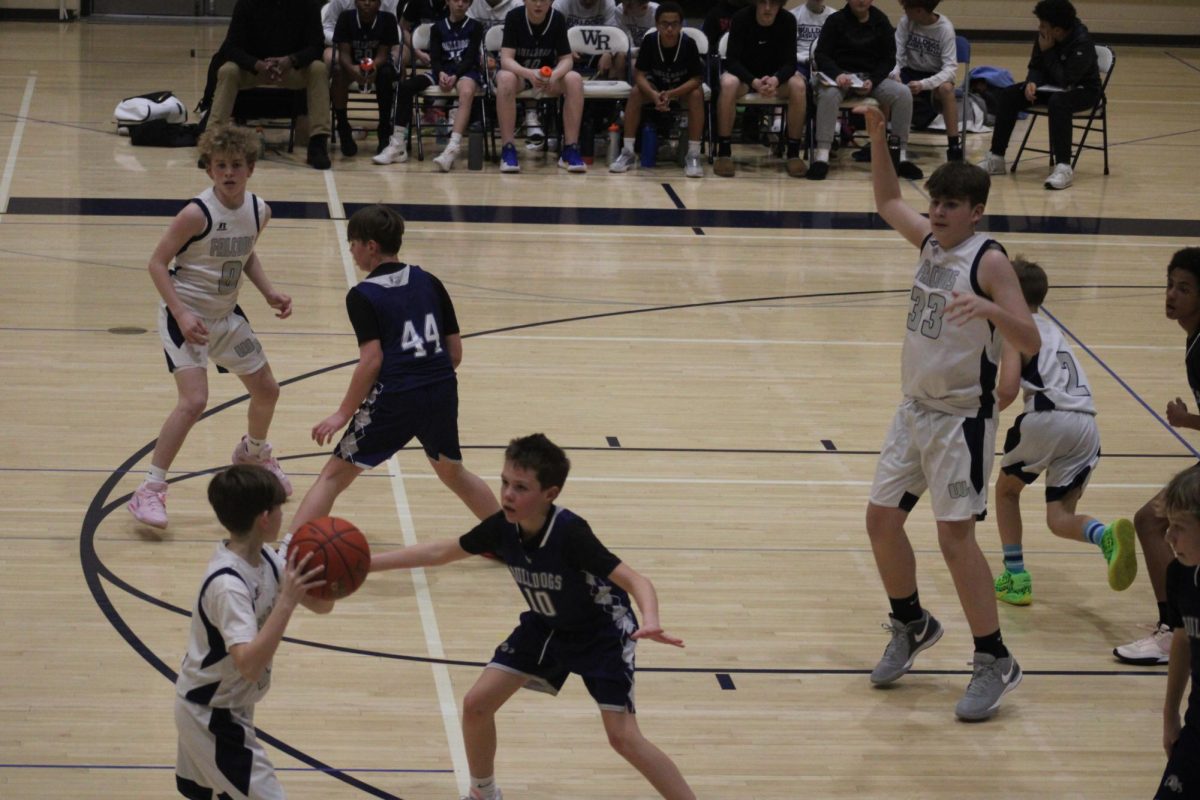 On January 25th, 7th grader Leland Epling waits for his teammate to pass him the ball to shoot and score against Lawrence.