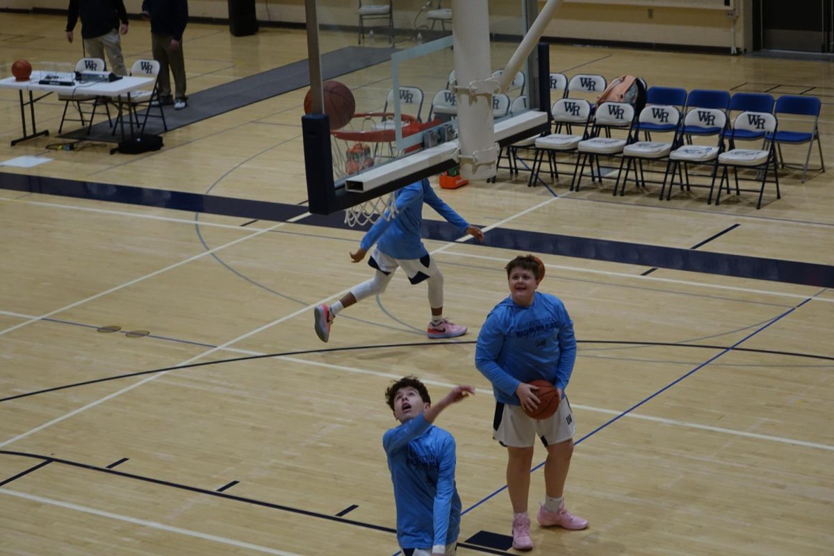 8th Grader Brooks Ballard shoots the basketball into the net at the WRMS home basketball game for practice before the game on January 30th.