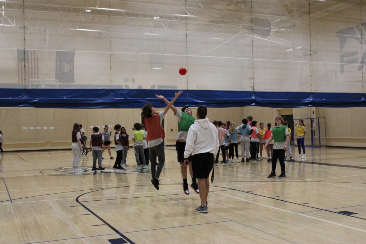 On February 6th during 2nd hour PE class, Coach Garland throws the ball in the air to Parker Dino and Elian Velazquez, as they jump to start a handball game.