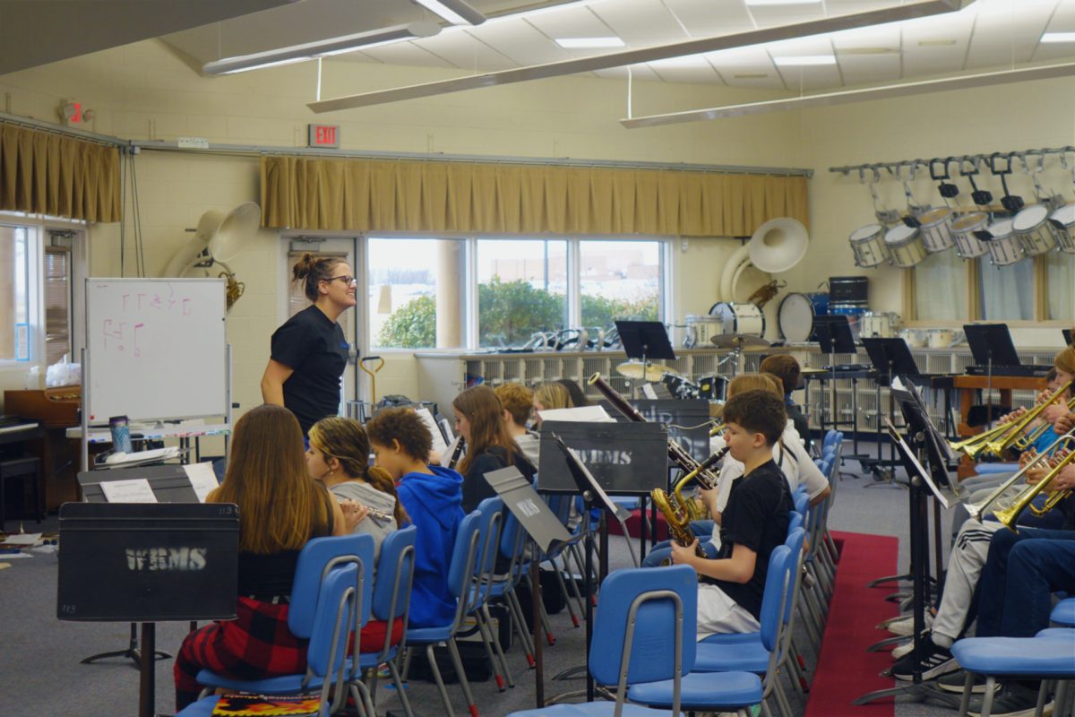 On February 7th during third hour, Mrs. Lambotte smiles as her 8th grade band students play their instruments to practice for their upcoming spring concert.