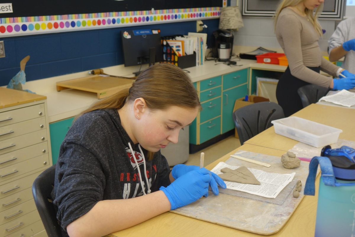 8th Grade student Alyssa Maxwell works on her clay ceramics tic-tac-toe board by carving, and shaping it during Mrs. Armstrongs 2nd hour Art on February 7th at WRMS. Photo by: Maggie Randall
