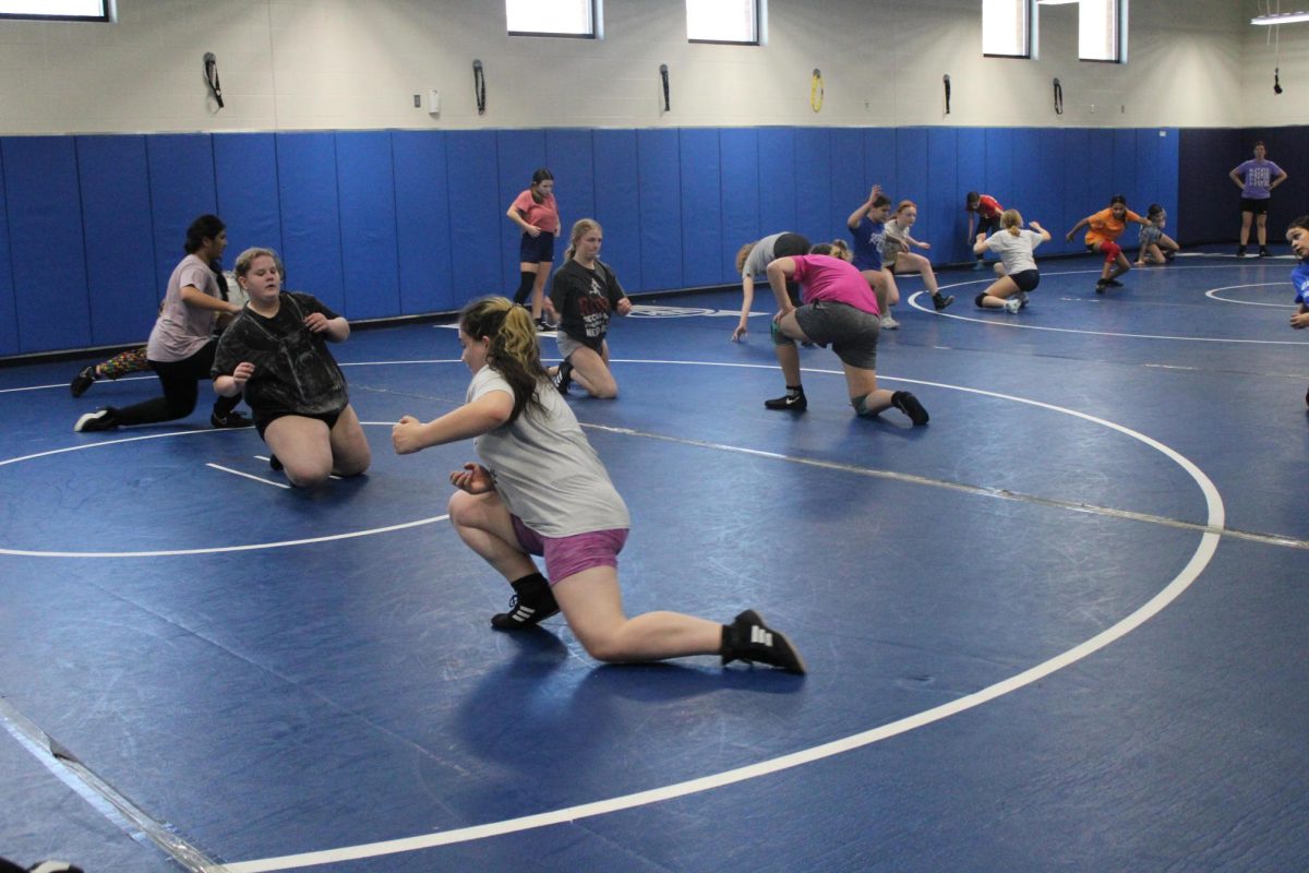 On 1/26/24 Cheyenne Waddell practice’s their neen slide on the mat in the wrestling room after school a few weeks before the wrestling match.
