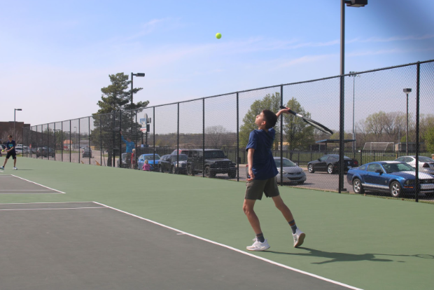 On March 28th, 7th grade Tennis player Manuel Martinez serves the ball during his match against Seaman at WRMS.