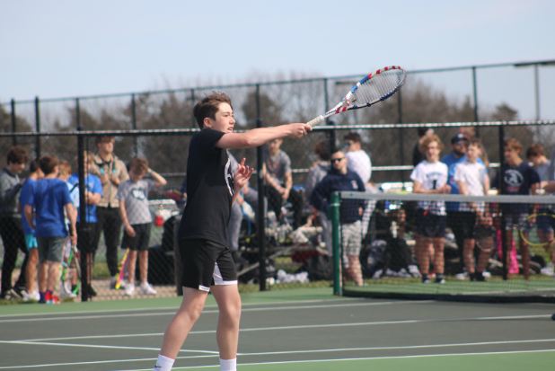 WRMS 8th grader, Carson O’Connor keeps the rally going by hitting the Tennis ball back to his opponent during his singles game. 