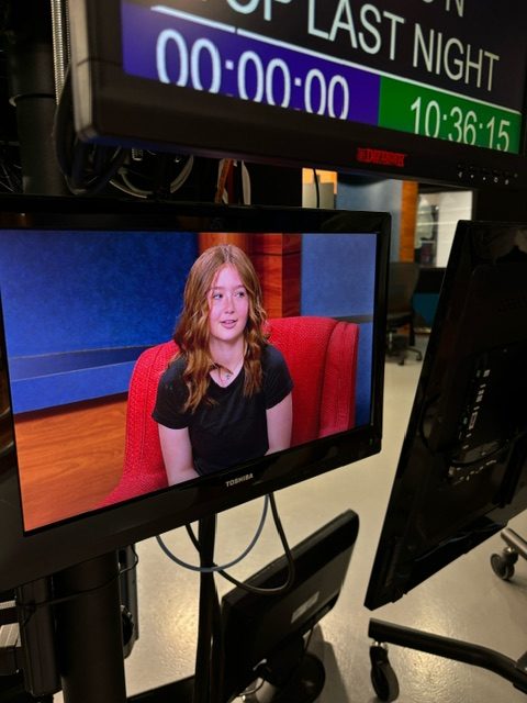 8th grader, Bailey Hill, sits on the iconic red chair from the “Red Couch Show” while getting interviewed at WIBW on Thursday, May 9. “It was fun because you get to experience what it’s actually like being interviewed on TV,” said Hill.