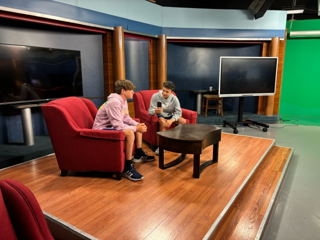 8th grader Logan Palmer interviews Vincent Henderson in the red chairs from the “Red Couch Show”. “I interviewed Vincent about if he liked Wendy’s or McDonald’s better,” said Palmer.