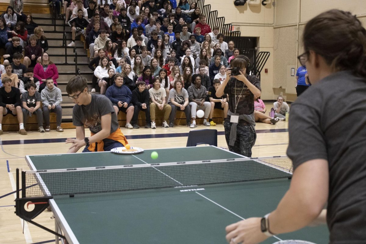  Band Teacher Mrs. Lambotte trys to get a ping pong ball on the bread before her opponent 8th grader Jax Johnson, while playing Sticky Situation on April 10th. “ It felt pretty good to win because he beat me last year,” Lambotte said.
