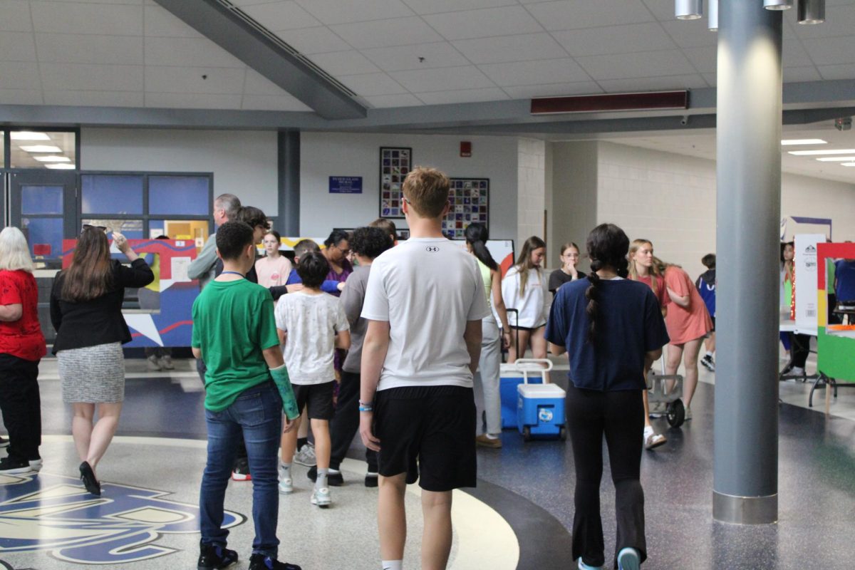 8th grade Spanish class starts to set up their food truck for the event in the commons on Monday, April 15th.