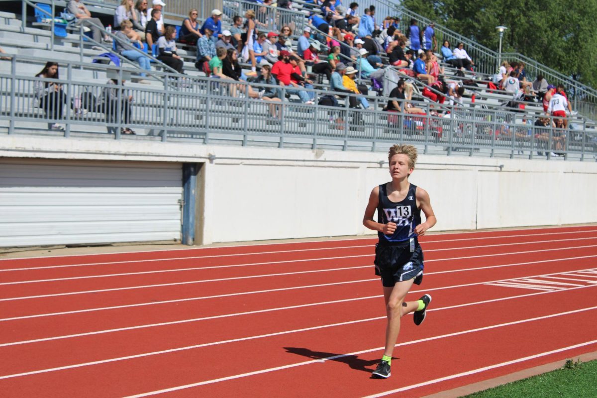 8th Grader, Brady Meek, hustles to the finish line during the 1600 meter race in Manattan, Kan