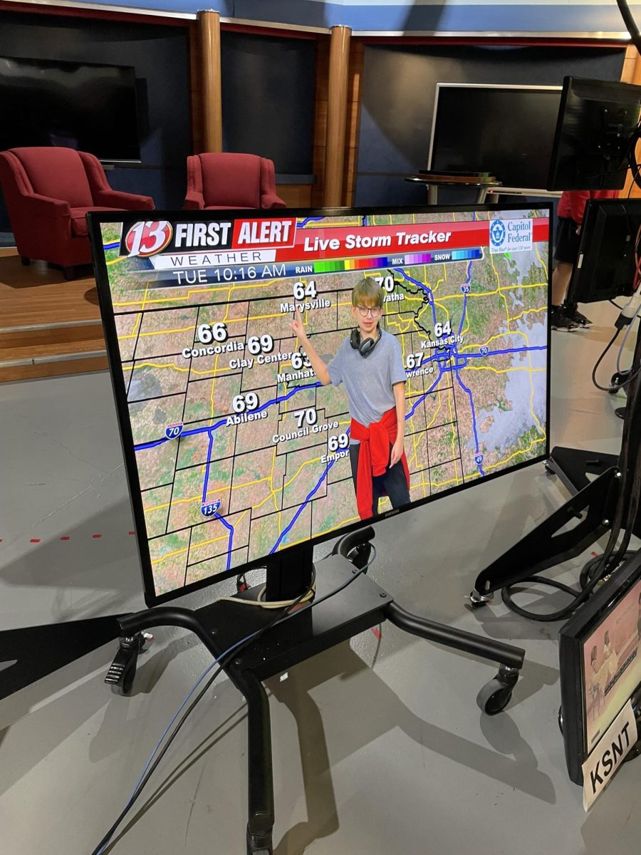 8th grader, Ben Maas, guides the class through weather predictions on the live storm tracker at WIBW, “It was cool to see how everything shows up on the TV through the green screen,” said Maas.